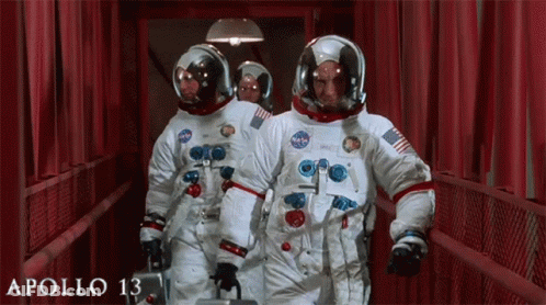 Astronauts Walking Down Hallway With Apollo 13 Poster GIF