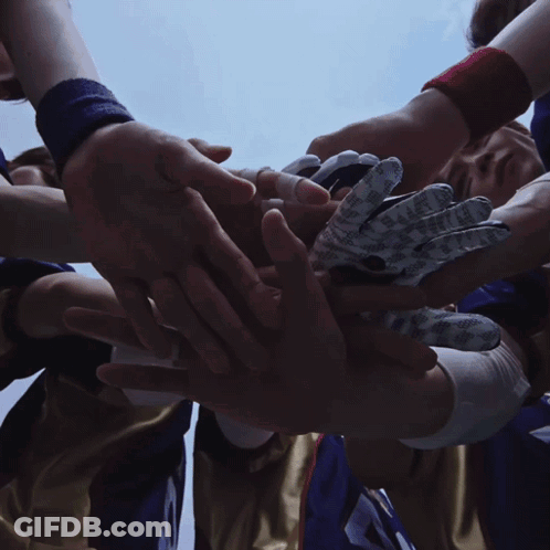 Athletes Huddled With Hands In Air GIF