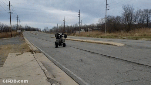 ATV Driving Down Road With Power Lines GIF