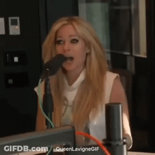 Avril Lavigne Is Singing Into A Microphone In A Radio Studio . GIF