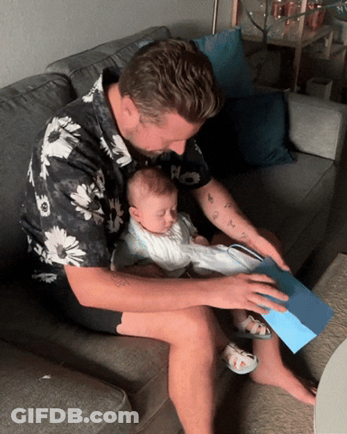 Baby Boy And Daddy Fix Diaper On The Bag GIF