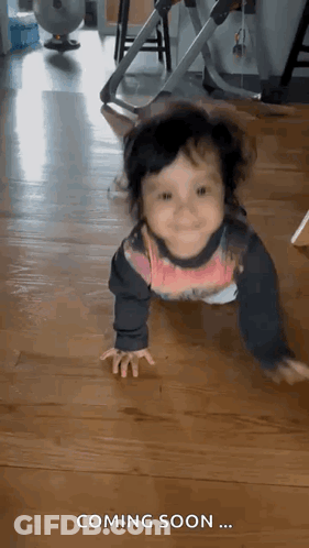 Baby Crawling On Wooden Floor Saying Coming Soon GIF