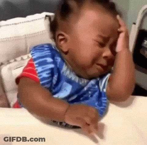 Baby Crying In Crib Holding Head GIF
