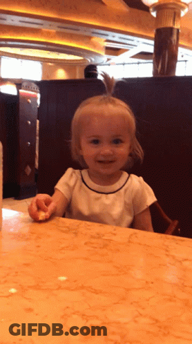 Baby Crying In Crowd Held By Woman GIF