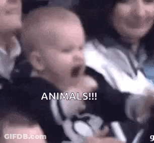 Baby Crying In Crowd Held By Woman GIF
