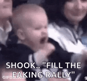Baby Crying In Crowd Held By Woman GIF