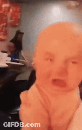 Baby Crying In Restaurant With Woman Behind GIF