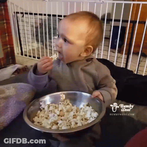 Baby Eating Popcorn From Bowl Saying Bumpy Woof GIF