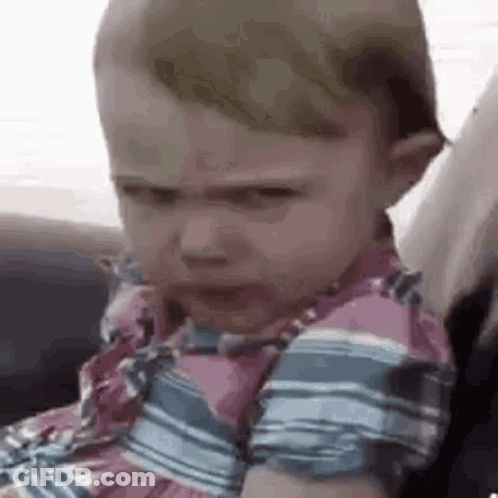 Baby Girl In Car Seat Making Funny Face GIF