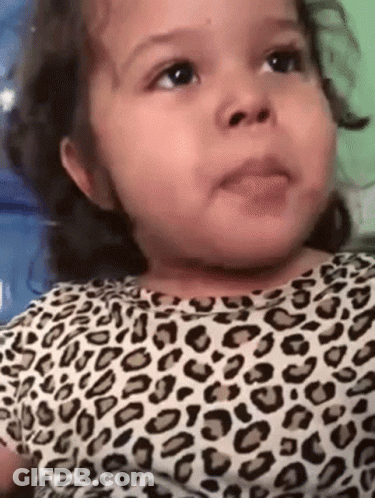 Baby Girl In Leopard Print Shirt Making Funny Face GIF
