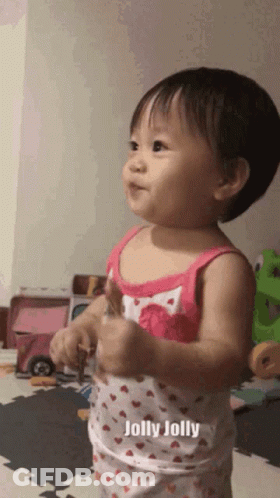 Baby Girl In Pink Tank Top Saying Jolly Jolly GIF