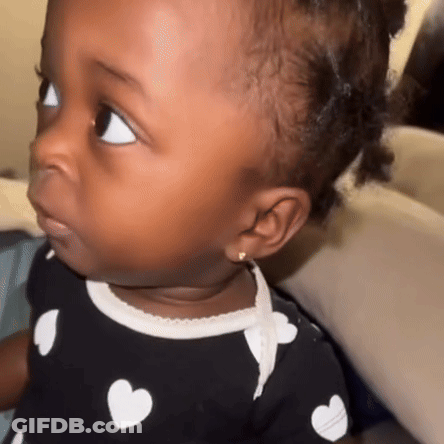 Baby Girl In Polka Dot Shirt With Hearts GIF