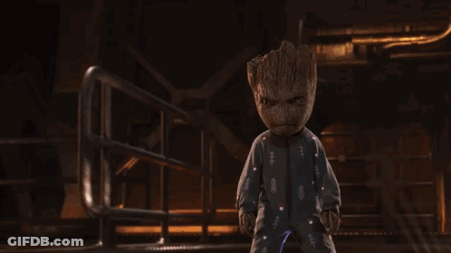 Baby Groot In Pajamas Standing In Dark Room GIF
