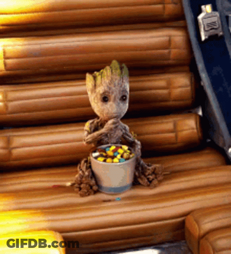 Baby Groot Sitting In Chair With Candy GIF