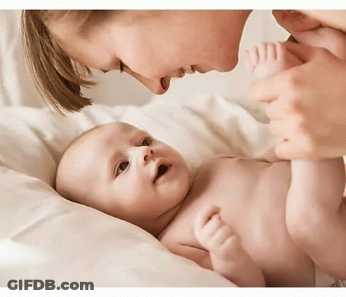 Baby Holding Birthday Present Saying Happy Birthday GIF