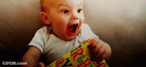 Baby Holding Birthday Wrapping Paper Mouth Open GIF