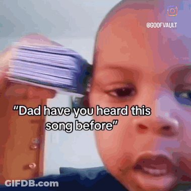 Baby Holding Cards To Ear Says Dad Have You Heard This Song Before GIF