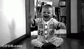 Baby In Baseball Uniform Sitting On Floor Black And White GIF