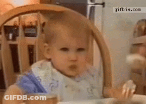 Baby In Bib Eating In High Chair GIF