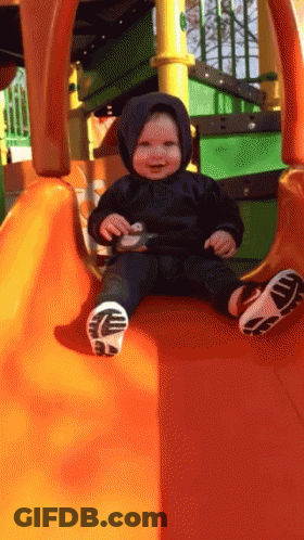 Baby In Black Hoodie On Orange Slide GIF