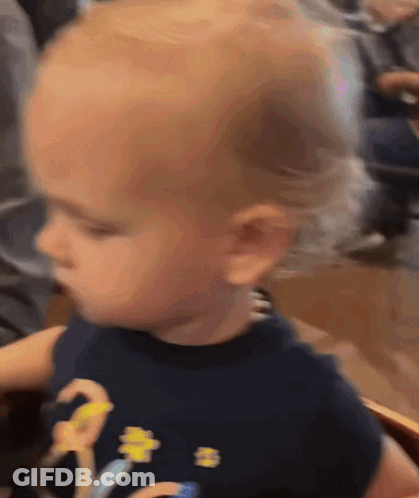 Baby In Black Shirt With Yellow Flower GIF