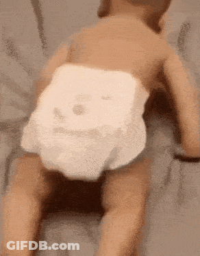 Baby In Diaper Crawling On Back On Bed GIF