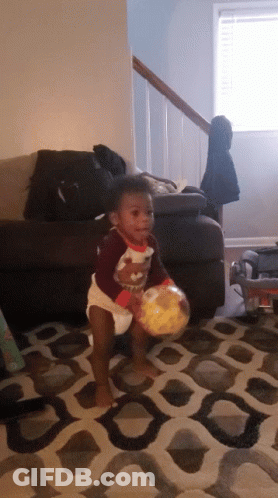 Baby In Diaper Playing With Ball GIF