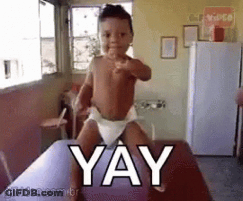 Baby In Diaper Pointing At Camera Saying Yay GIF
