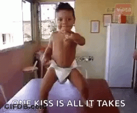Baby In Diaper Standing On Table GIF
