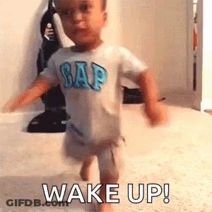 Baby In Gap Shirt Saying Wake Up GIF