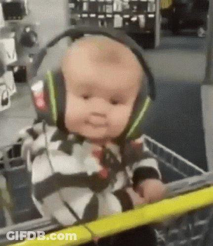 Baby In Headphones Sitting In Shopping Cart GIF