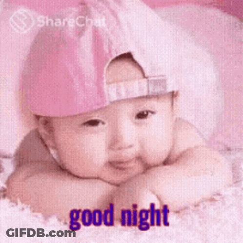 Baby In Pink Hat Laying On Bed Good Night GIF