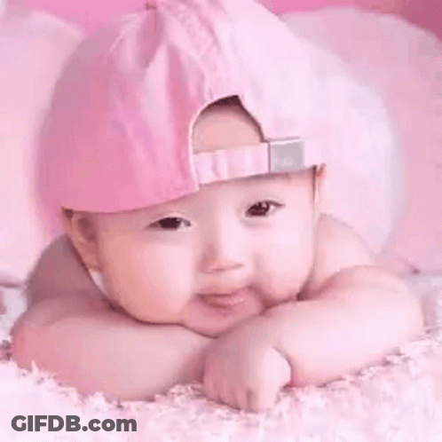 Baby In Pink Hat Laying On Pink Blanket GIF