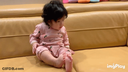 Baby In Pink Outfit Sitting On Couch With Imgplay GIF