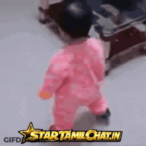 Baby In Pink Outfit Walking In Front Of Startamilchat.in GIF