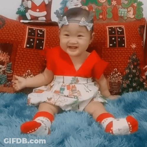Baby In Red And White Dress On Blue Blanket GIF