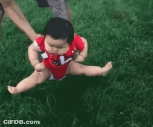 Baby In Red Bodysuit Being Held GIF