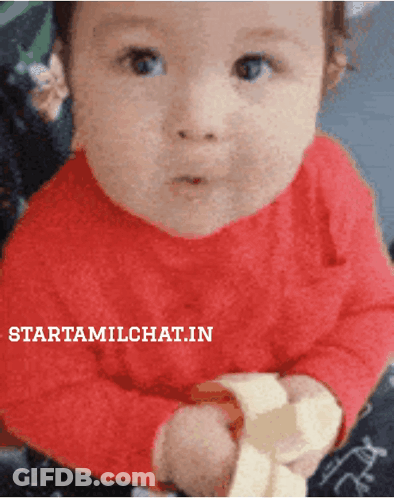 Baby In Red Shirt Holding Banana With Starttamilchat.in GIF