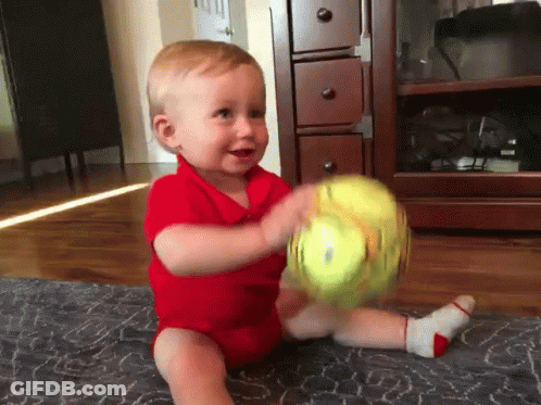 Baby In Red Shirt Playing With Ball GIF