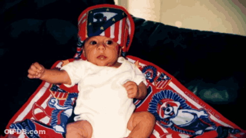 Baby In Red White Blue Hat And White Shirt GIF