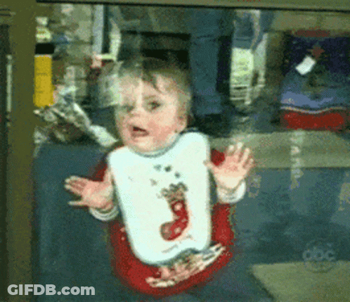 Baby In Reindeer Bib Looking Out Window GIF