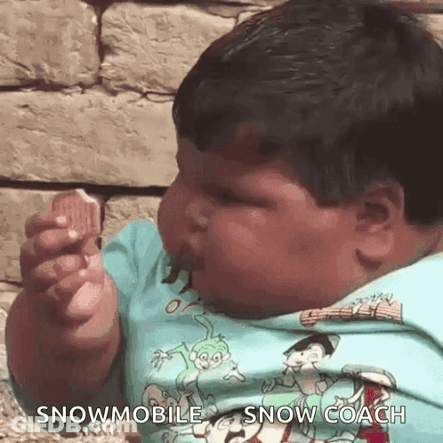 Baby In Snowmobile Shirt Eating GIF