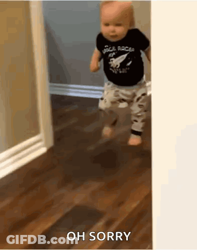 Baby In Space Racer Shirt Walking On Wooden Floor GIF
