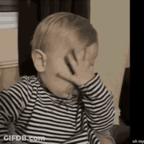 Baby In Striped Shirt Covering Face GIF