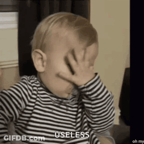 Baby In Striped Shirt Covering Face Saying Useless GIF