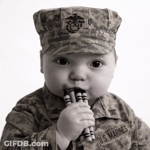 Baby In U.S. Marines Uniform Chewing Crayons GIF