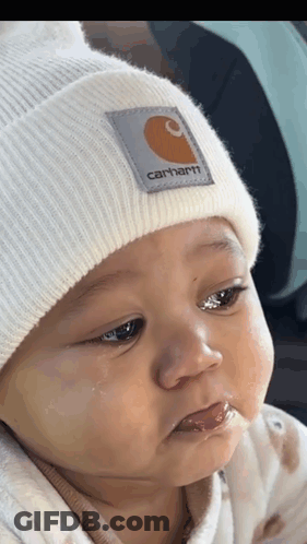 Baby In White Carhartt Beanie Looking At Camera GIF