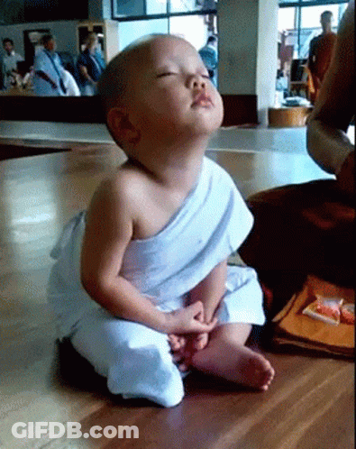 Baby In White Robe With Eyes Closed GIF