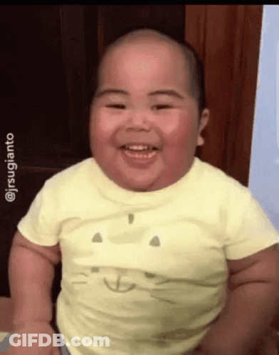 Baby In Yellow Cat Face Shirt Smiling GIF