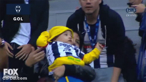 Baby In Yellow Hat Held By Man In Fox Deportes Ad GIF